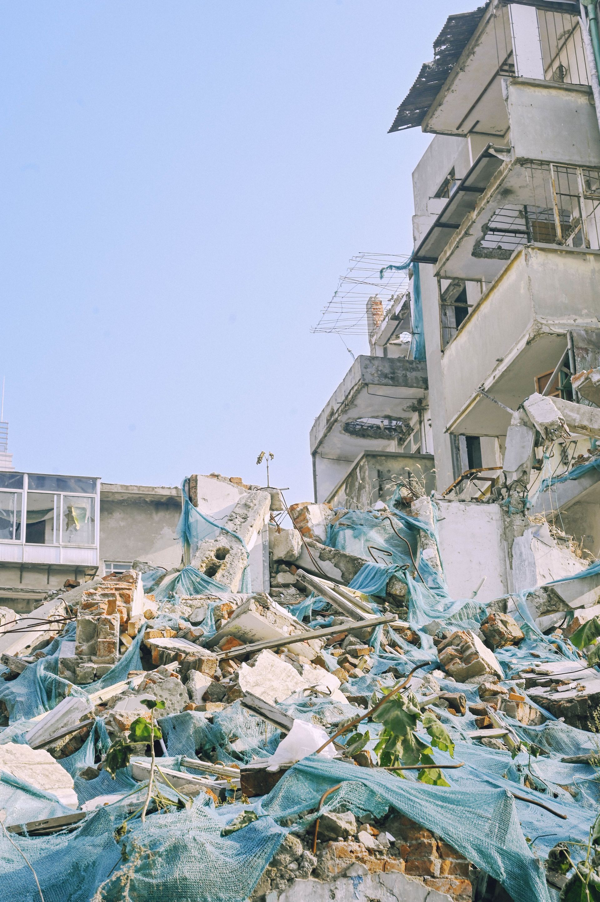 Demolished urban building with rubble and debris, showcasing construction dismantling.