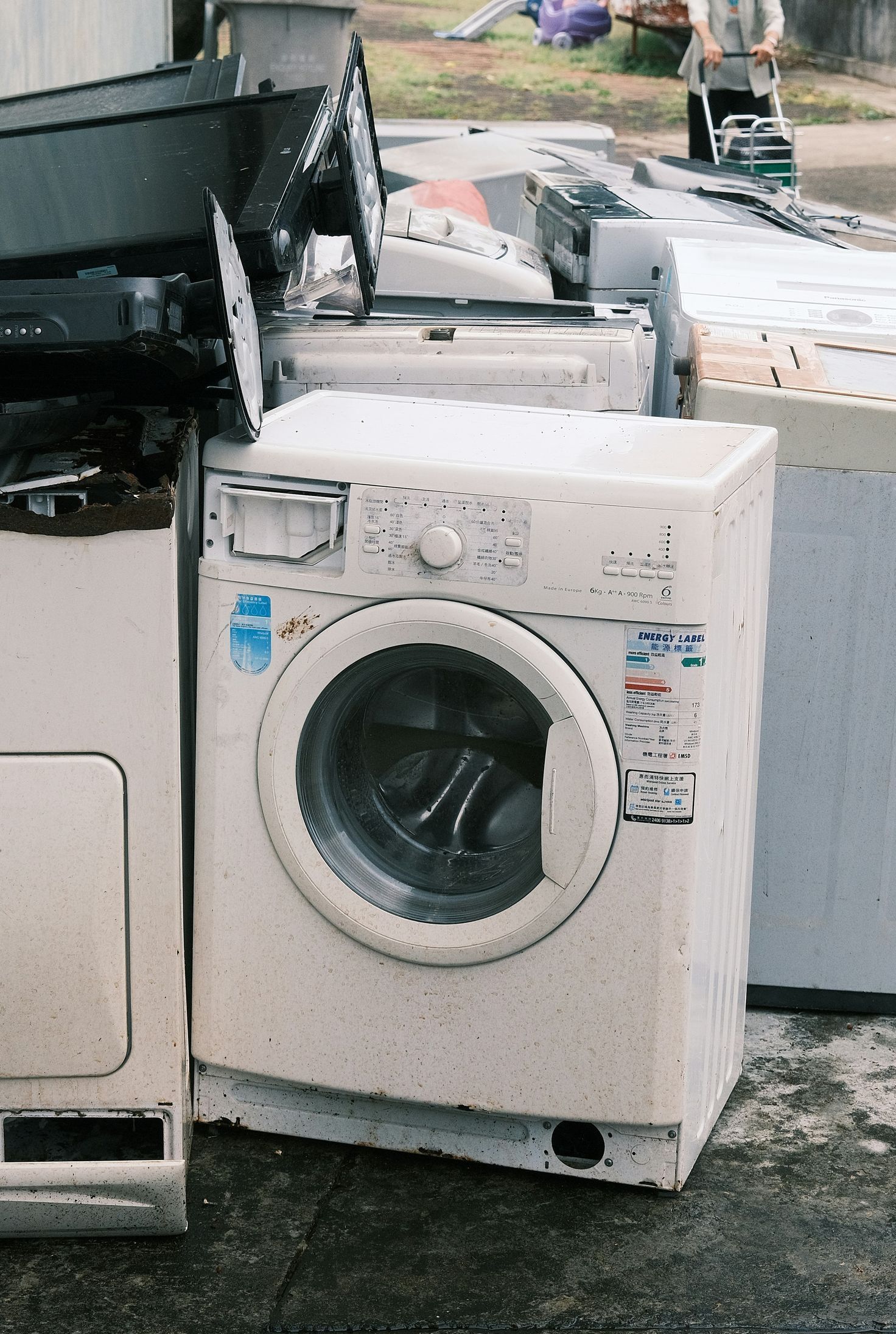 a pile of washing machines sitting next to each other